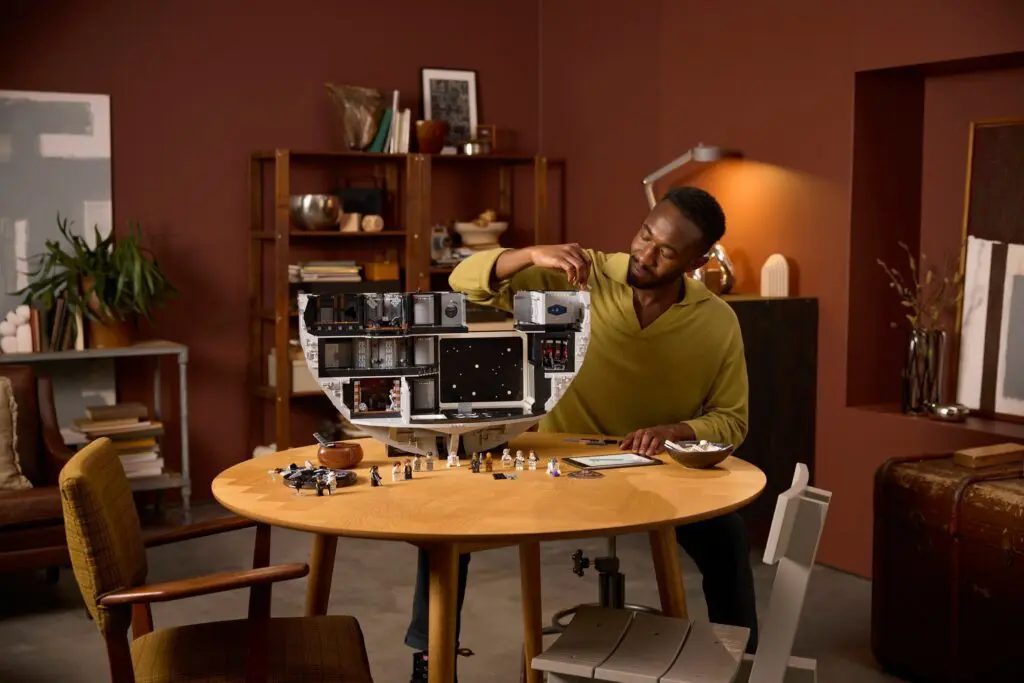 Man assembling detailed model spaceship
