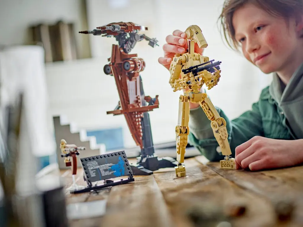 Boy assembling LEGO Star Wars droid
