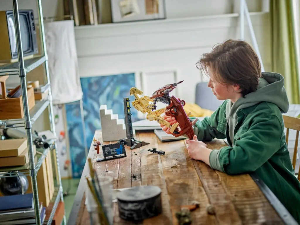 Kid engaged with dinosaur construction set