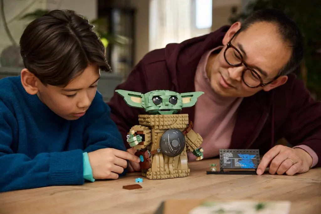 Boy and man building Baby Yoda LEGO