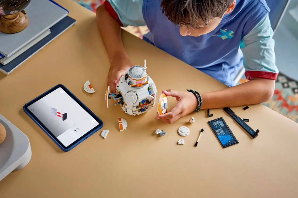 Kid constructing robot using digital guide