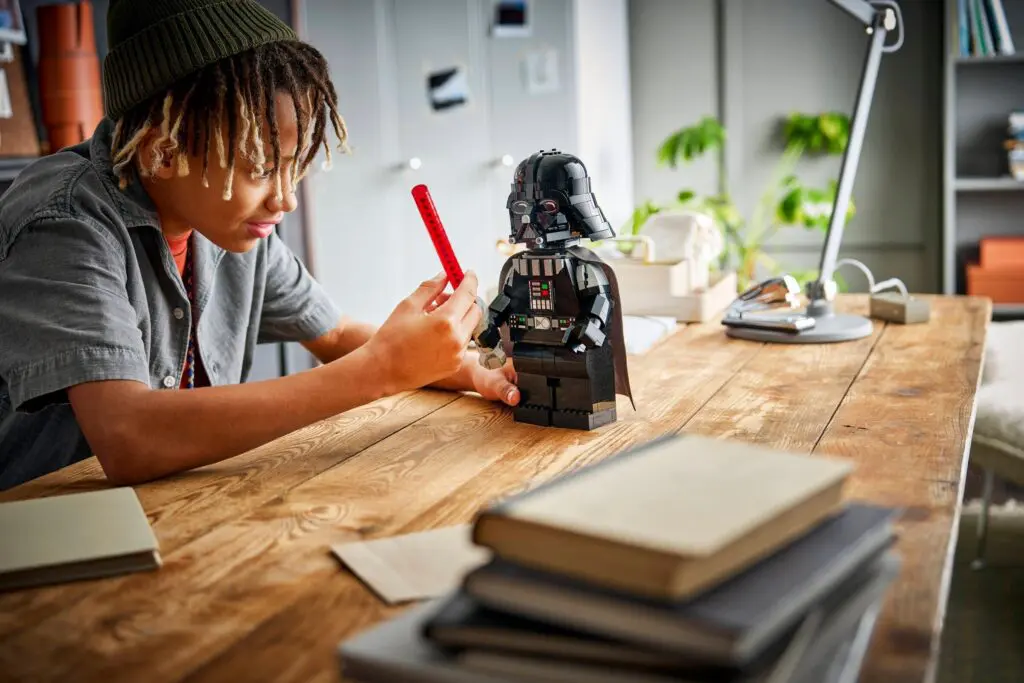 Child playing with Darth Vader LEGO set