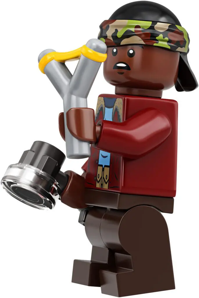 Toy figure holding slingshot and camera
