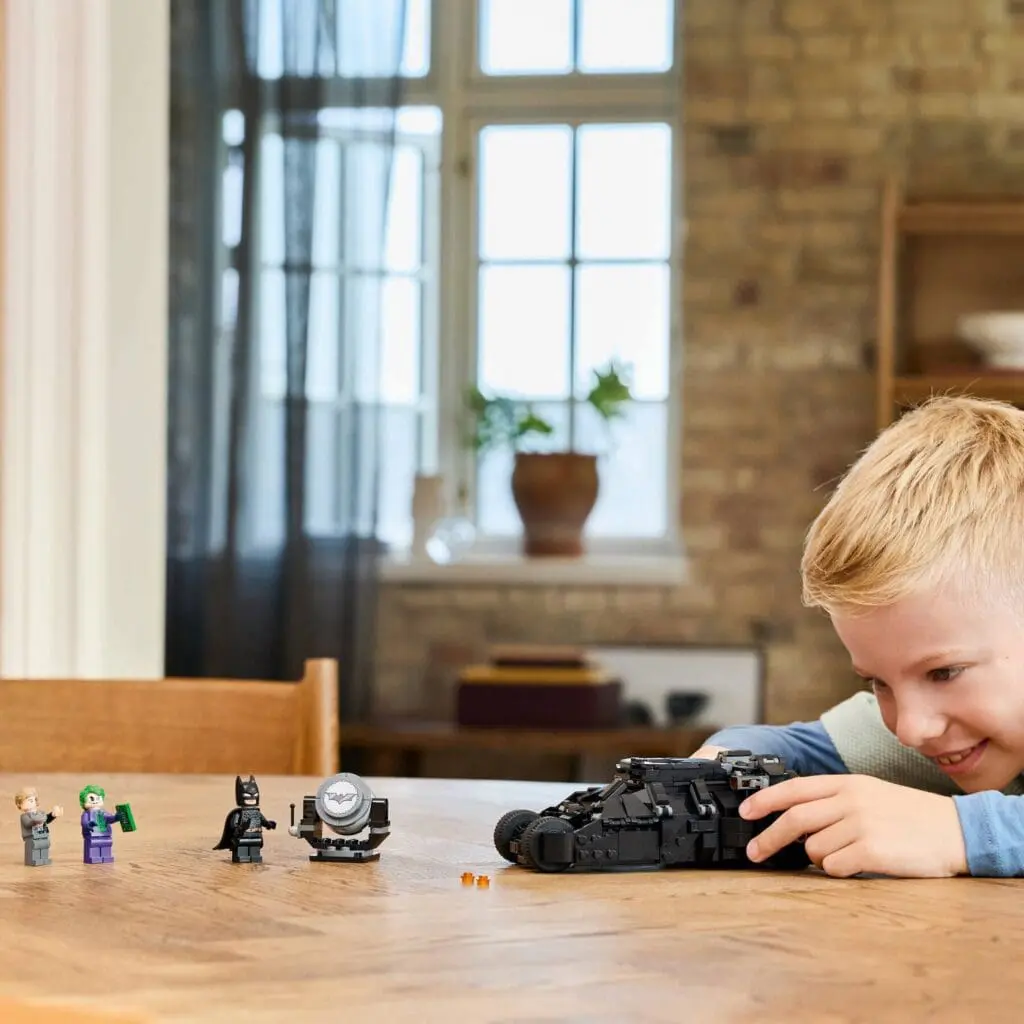 Child playing with Batman LEGO set