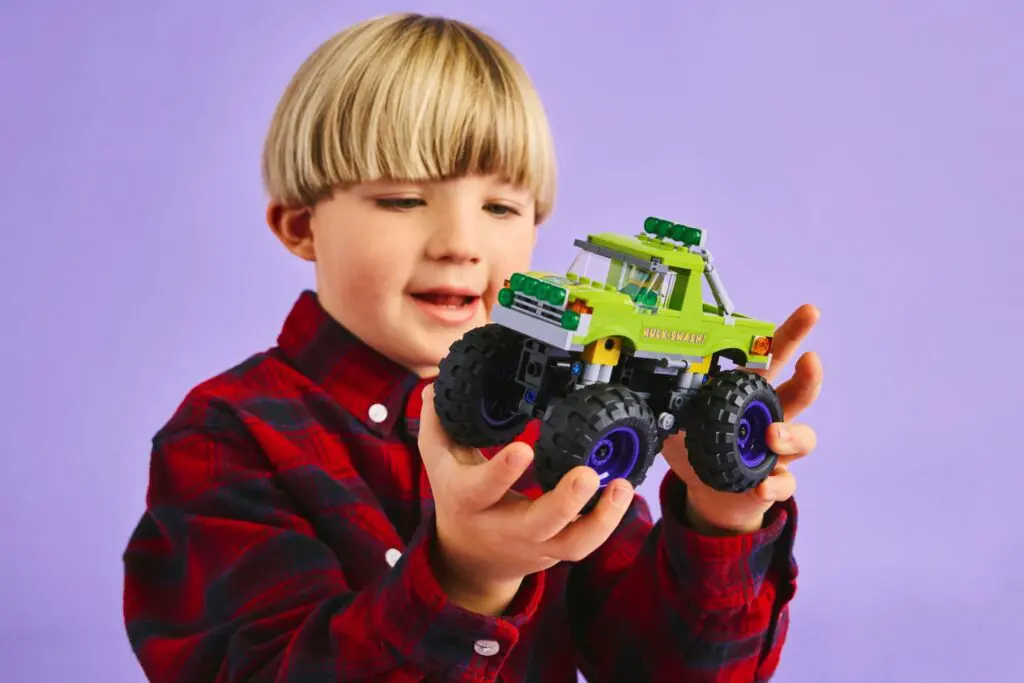 Kid enjoys colorful toy vehicle