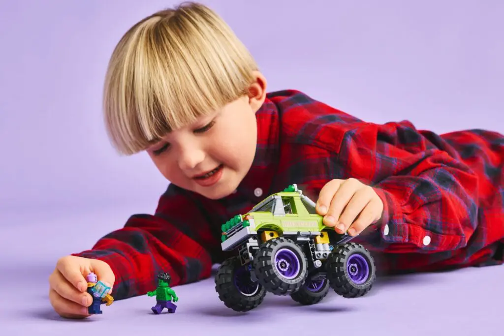 Kid in plaid shirt with toys