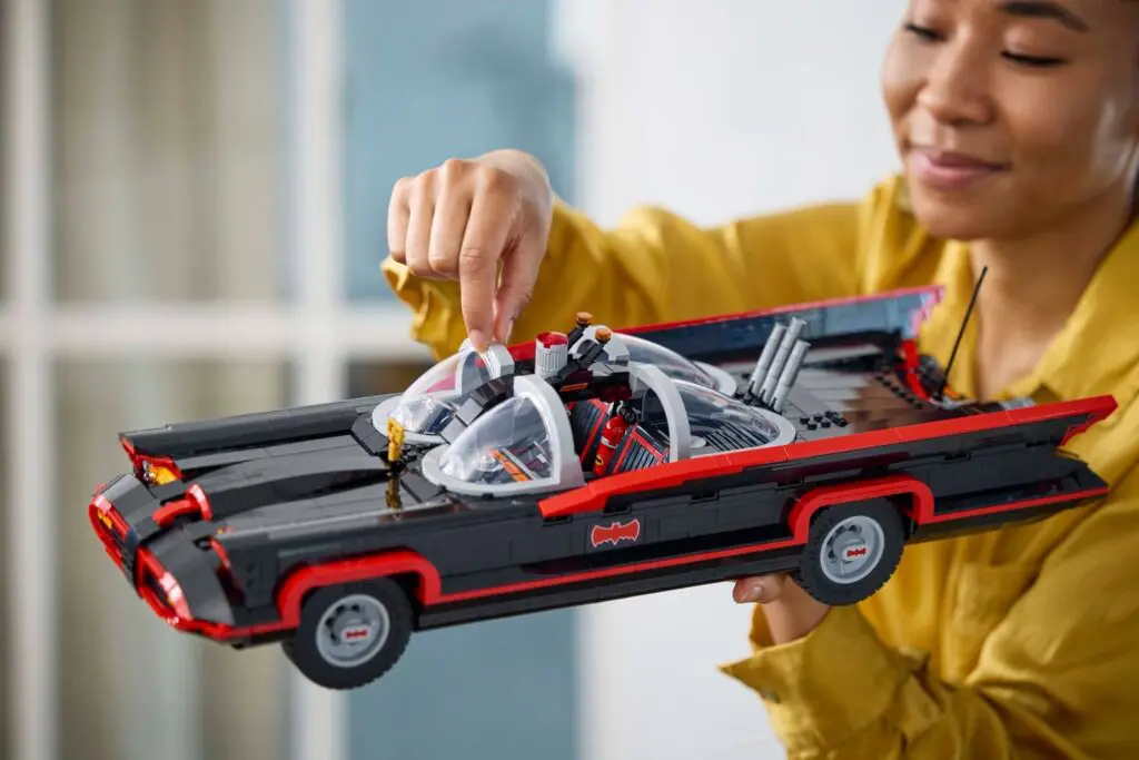 Smiling woman admiring model vehicle