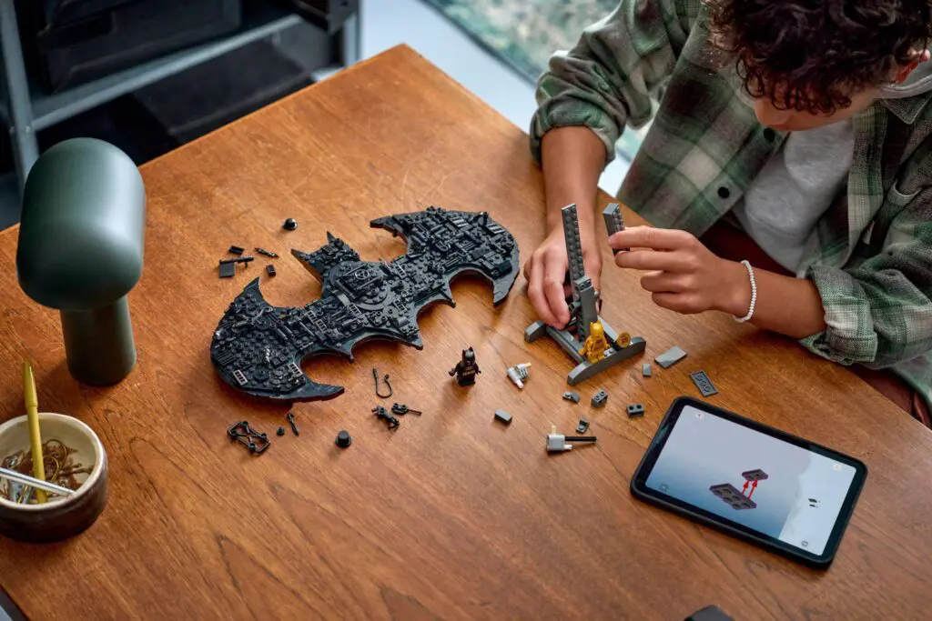 Assembling LEGO pieces on wooden table