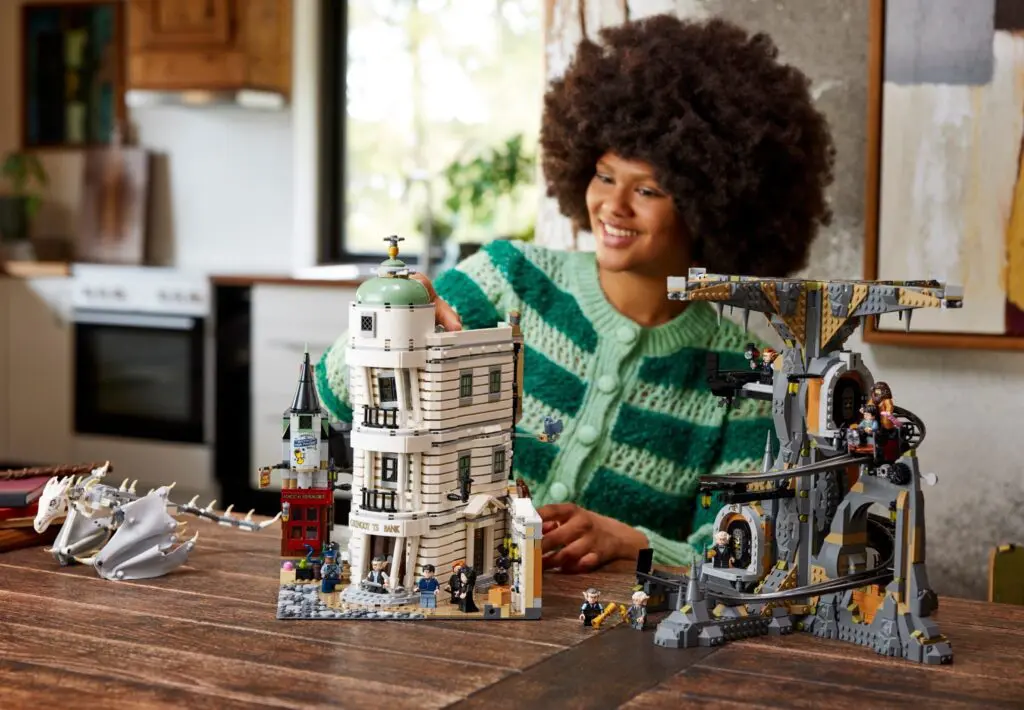 Enthusiast assembling detailed LEGO buildings and dragon