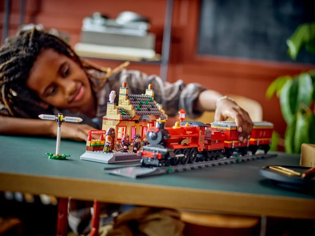Boy enjoying train station playset