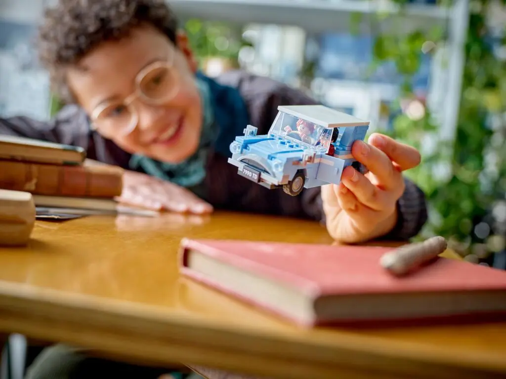 Person holding a toy car model