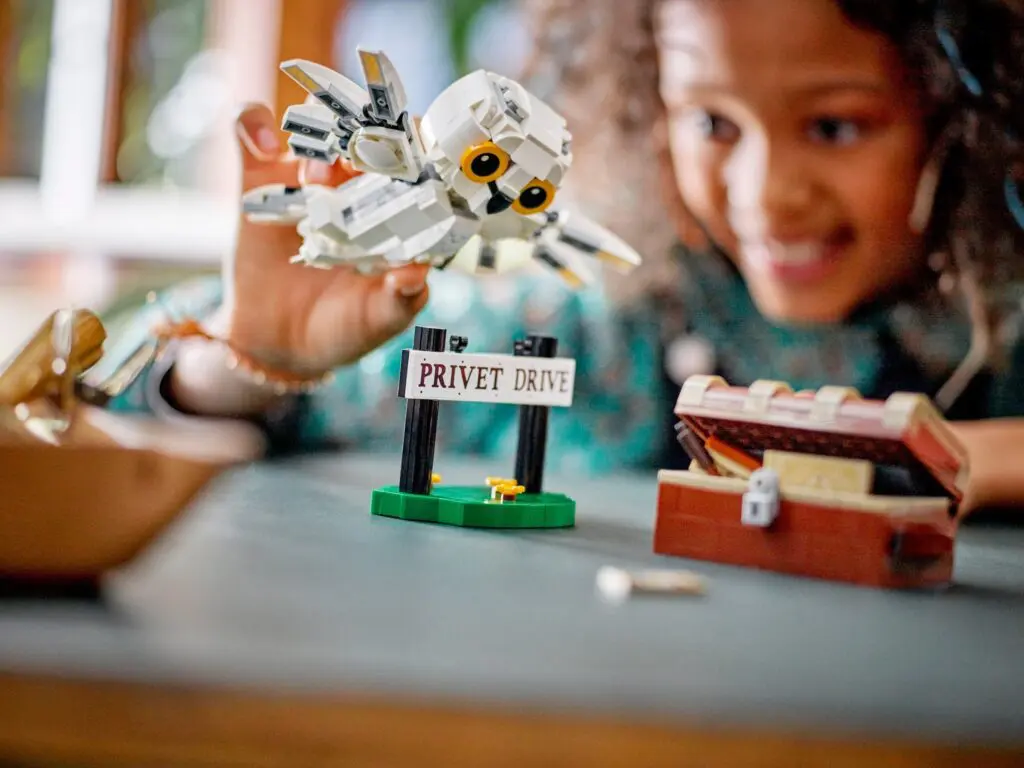 Smiling child with LEGO owl toy