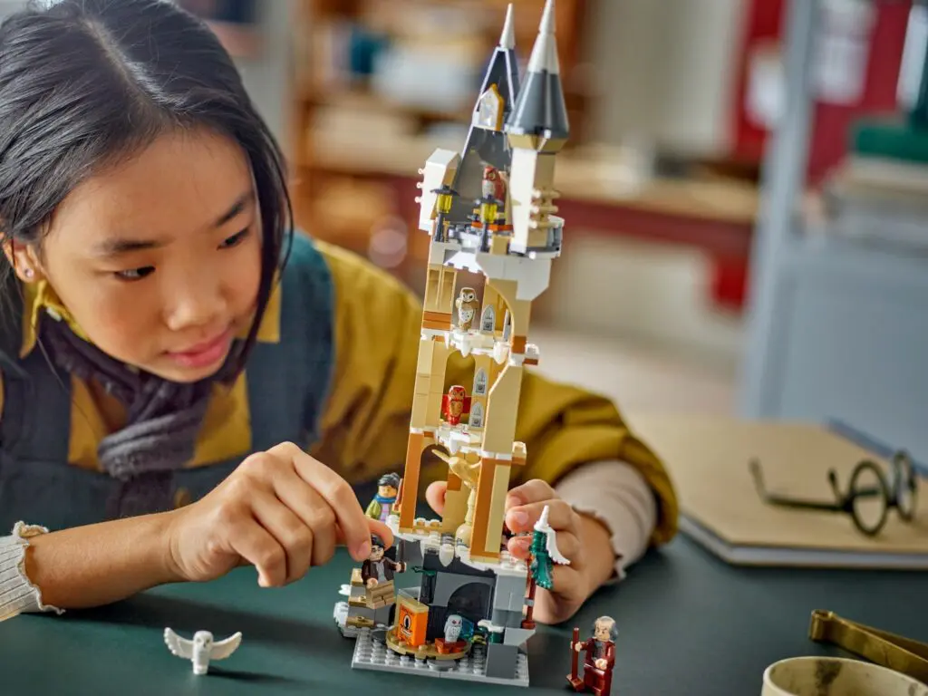 Girl assembling a LEGO castle set