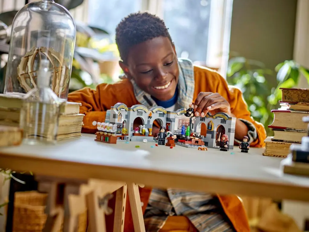 Child playing with building blocks at table