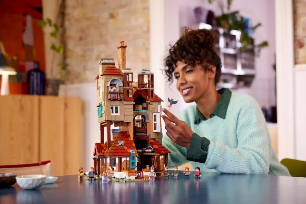 Woman building a detailed LEGO house