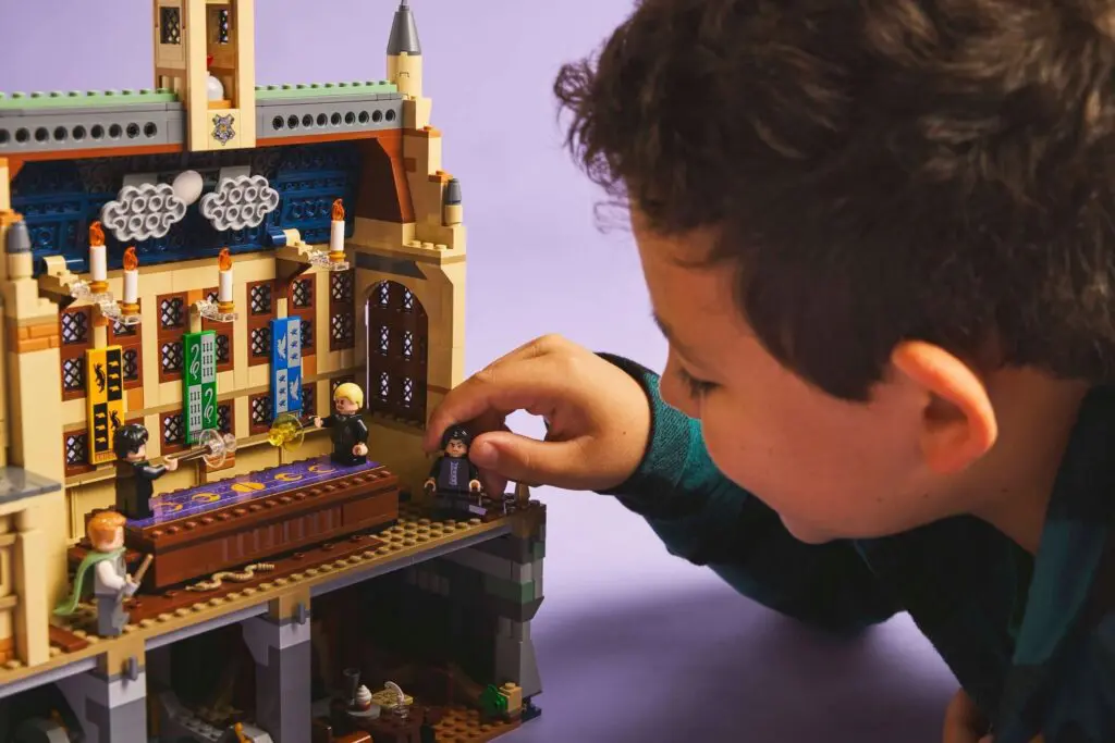 Child playing with Hogwarts LEGO set