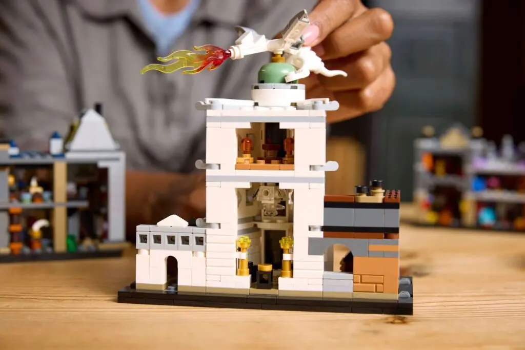 Hand placing dragon on LEGO set