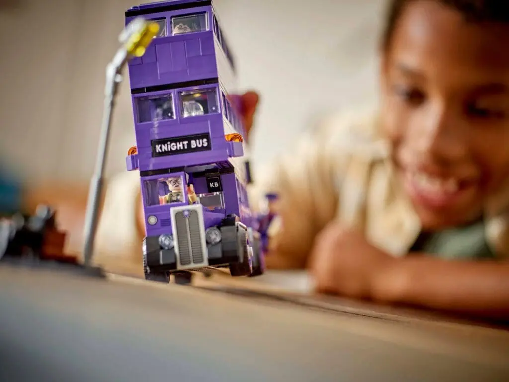 Smiling child with Knight Bus toy