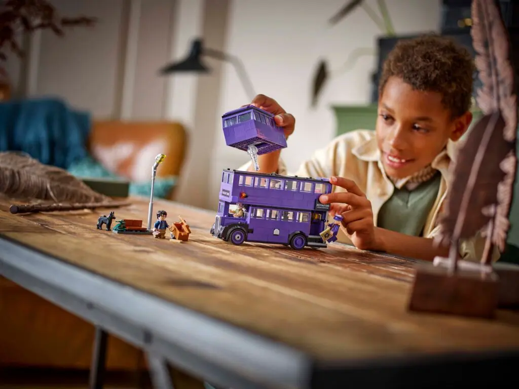 Child playing with purple toy bus
