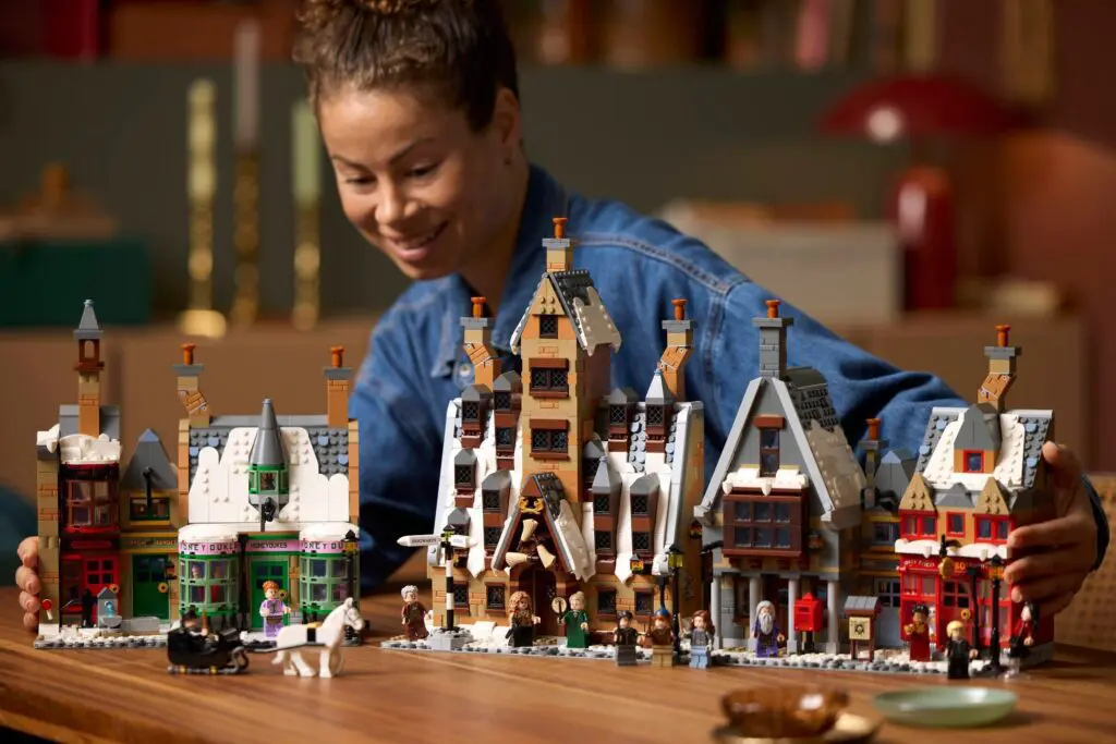 Smiling individual with LEGO winter scene