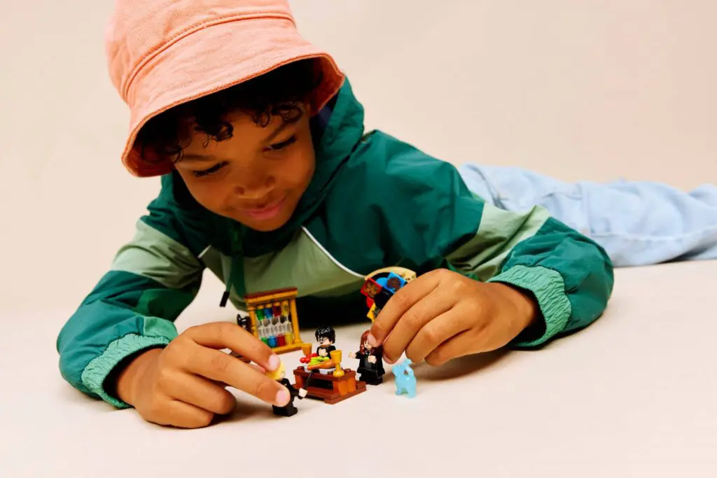 Kid in pink hat and green jacket