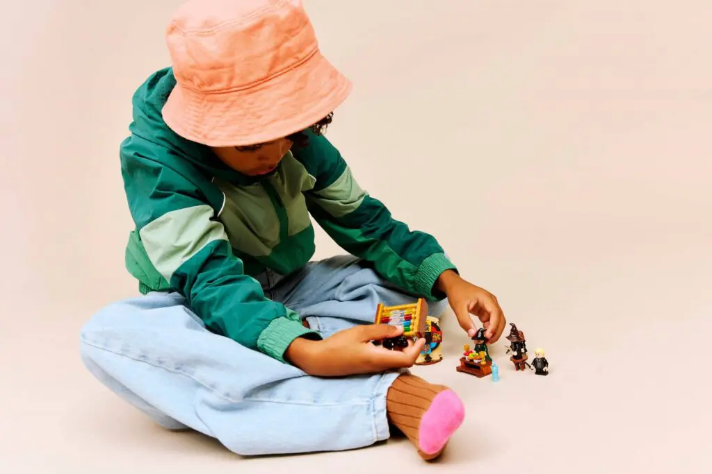 Youngster engaging with toys on beige background