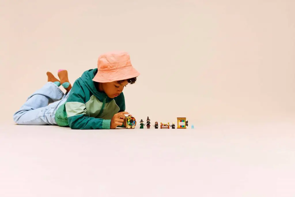 Young boy engaged with miniature figurines.