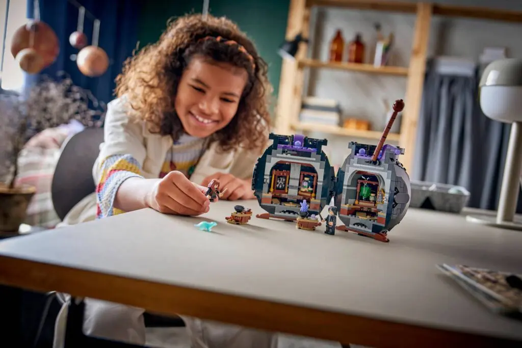 Smiling child assembling toy structures