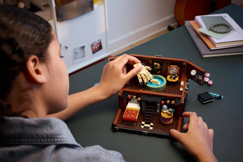 Child assembling a LEGO dollhouse set