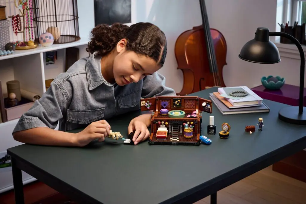 Kid arranging small figurines in diorama