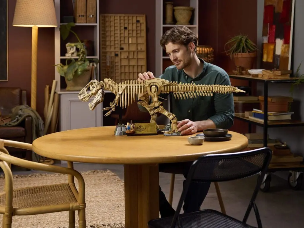 Individual constructing dinosaur replica indoors