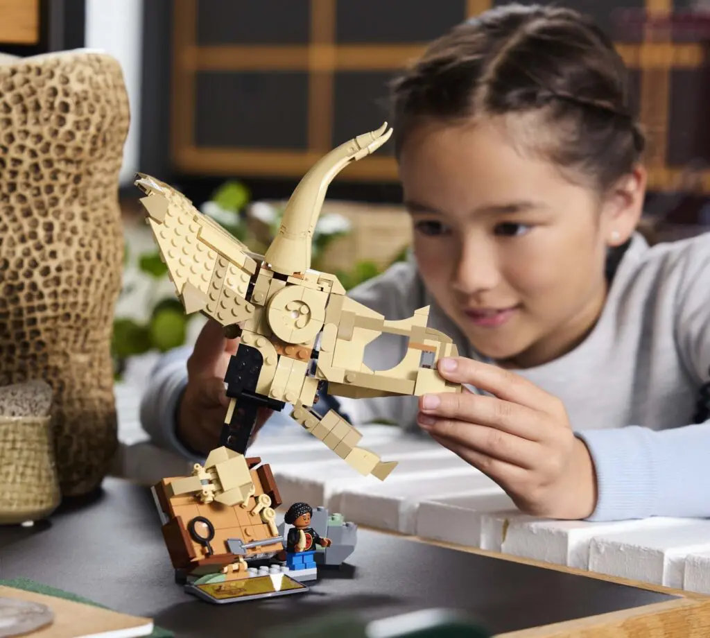 Child building LEGO owl set
