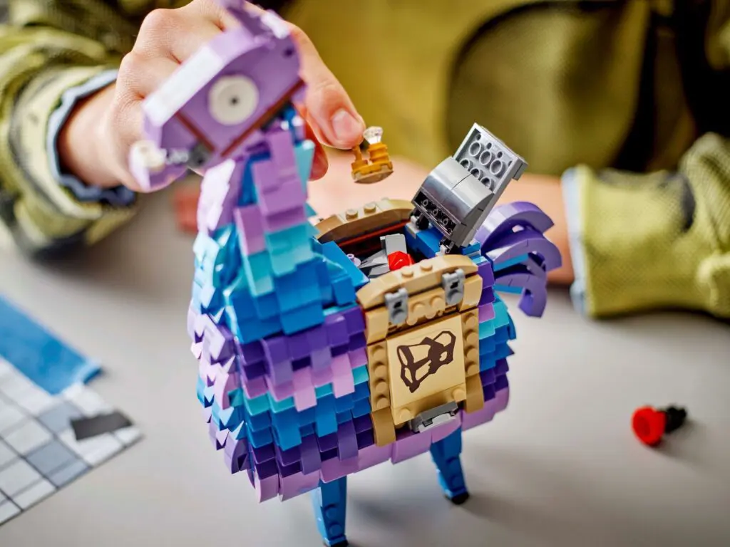 Child assembling a purple llama figure