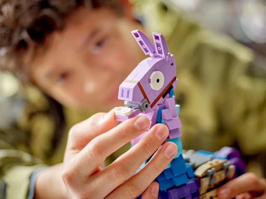 Kid assembling colorful LEGO animal