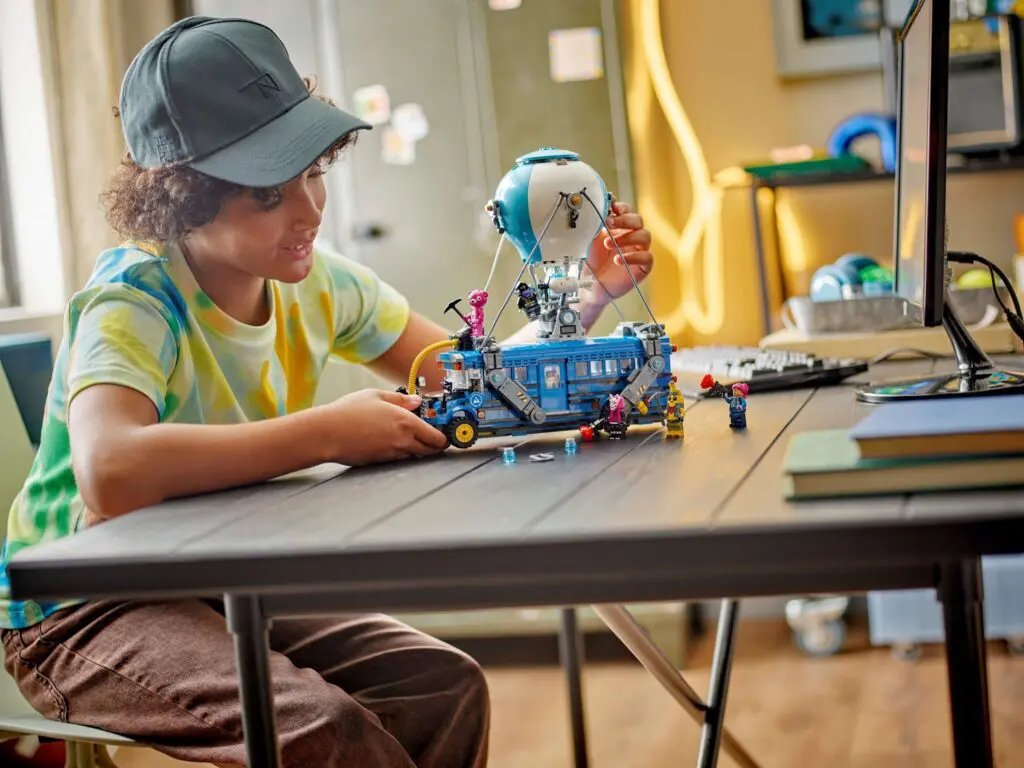 Kid assembling blue toy bus