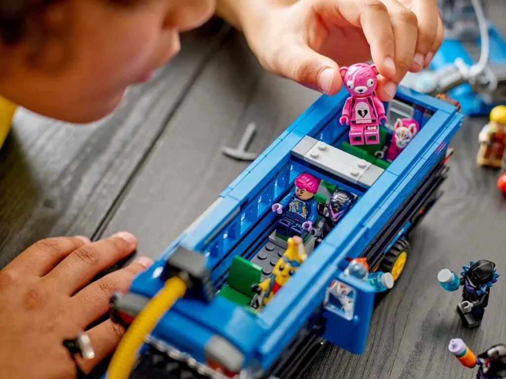 Close-up of child arranging LEGO minifigures.