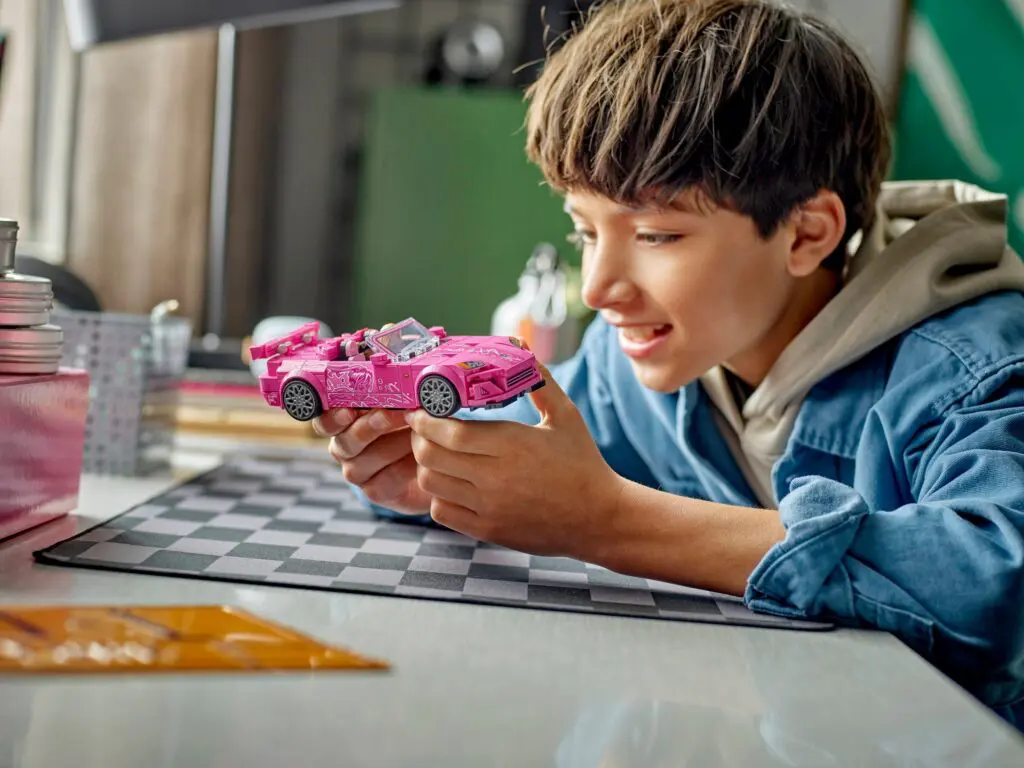 Happy child admiring toy vehicle