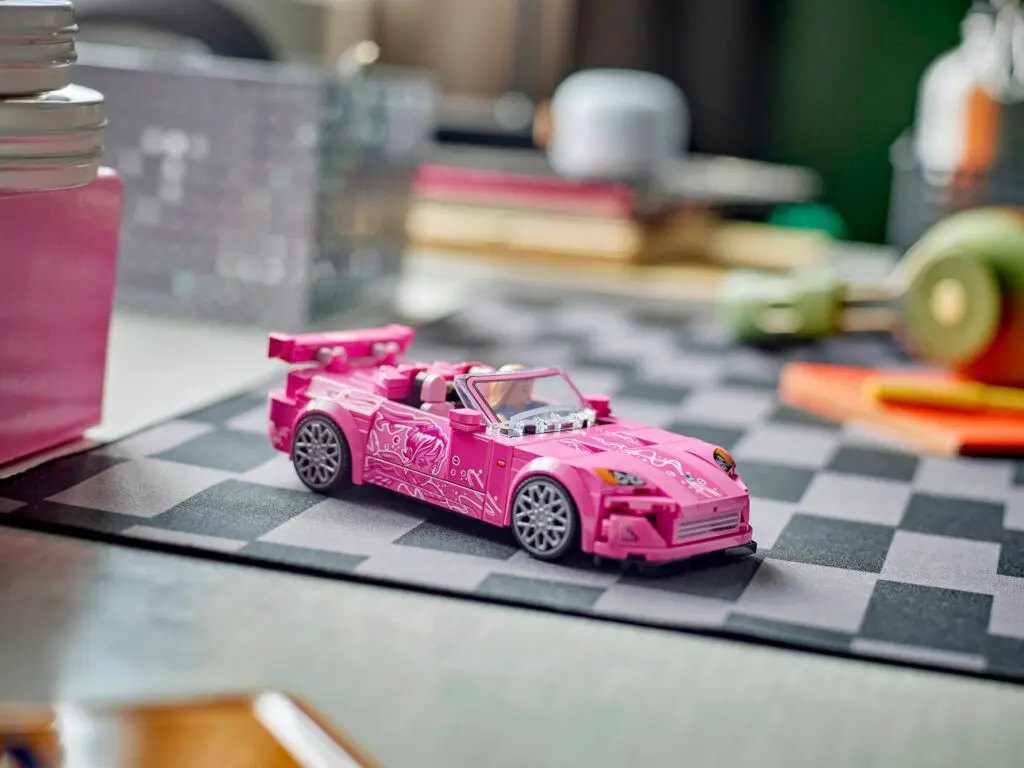 Pink toy car on checkered mat