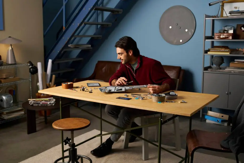 Focused man crafting in cozy room