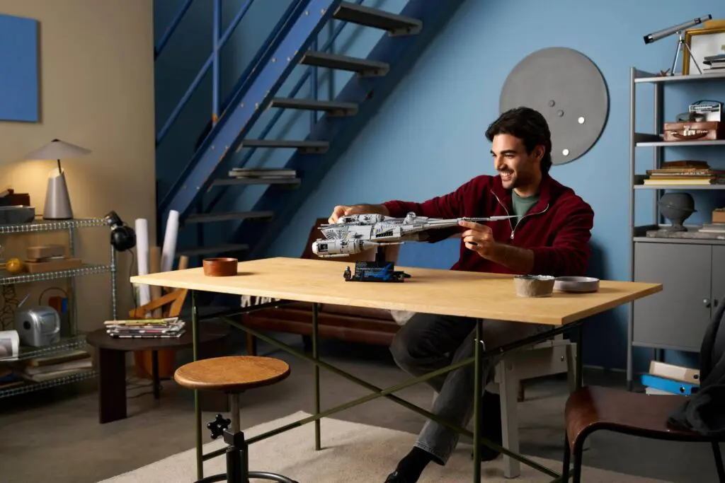 Enthusiast crafting model spaceship indoors