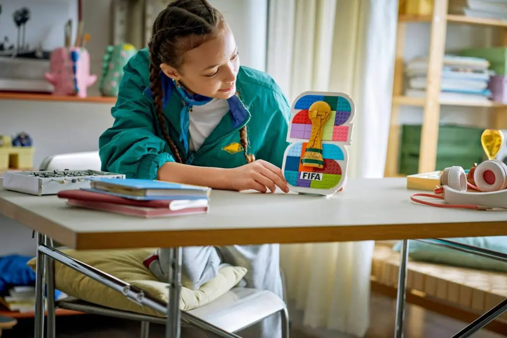 Young girl studying sports trophy replica