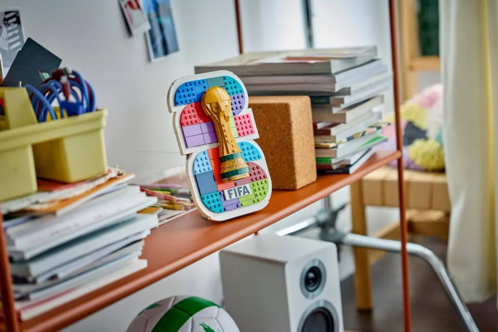 Colorful FIFA trophy among books