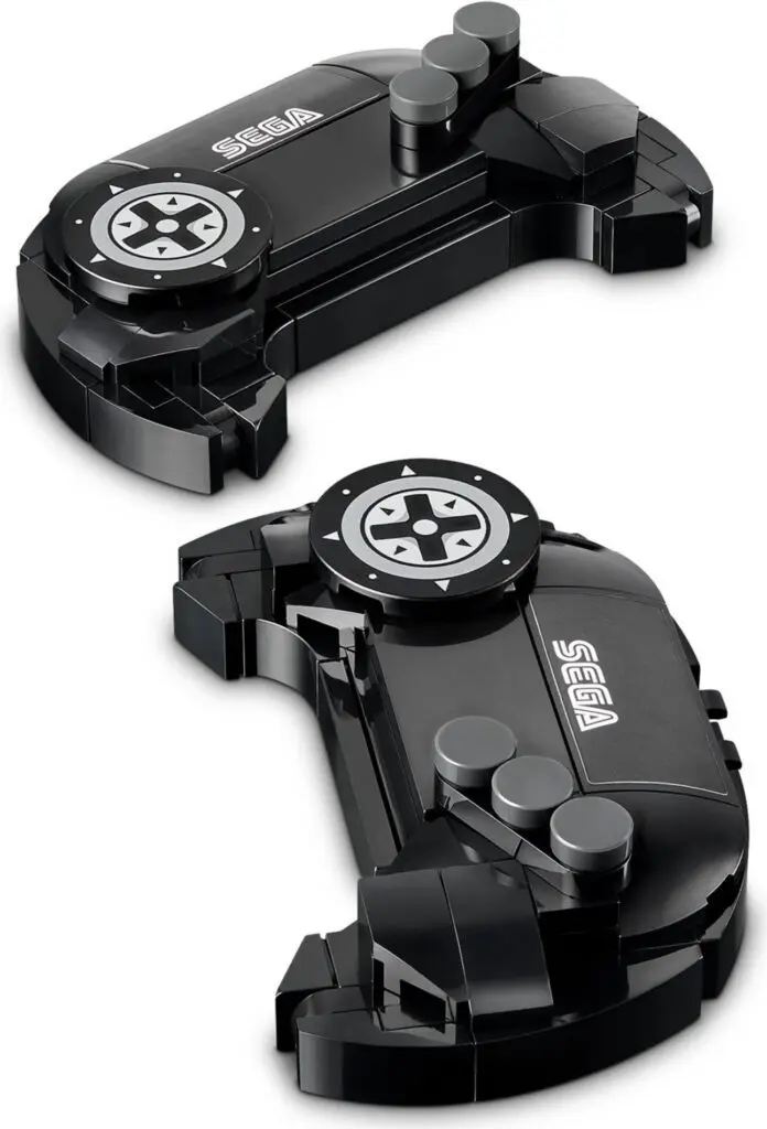 Black Sega controller pieces on white background