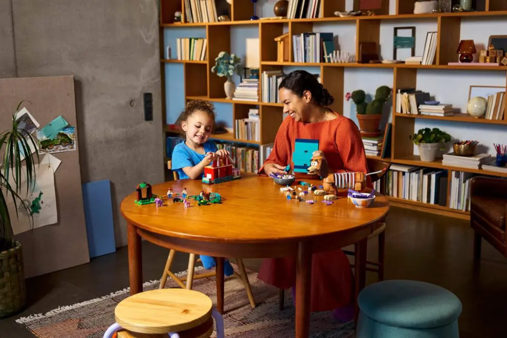 Child and adult playing with building blocks