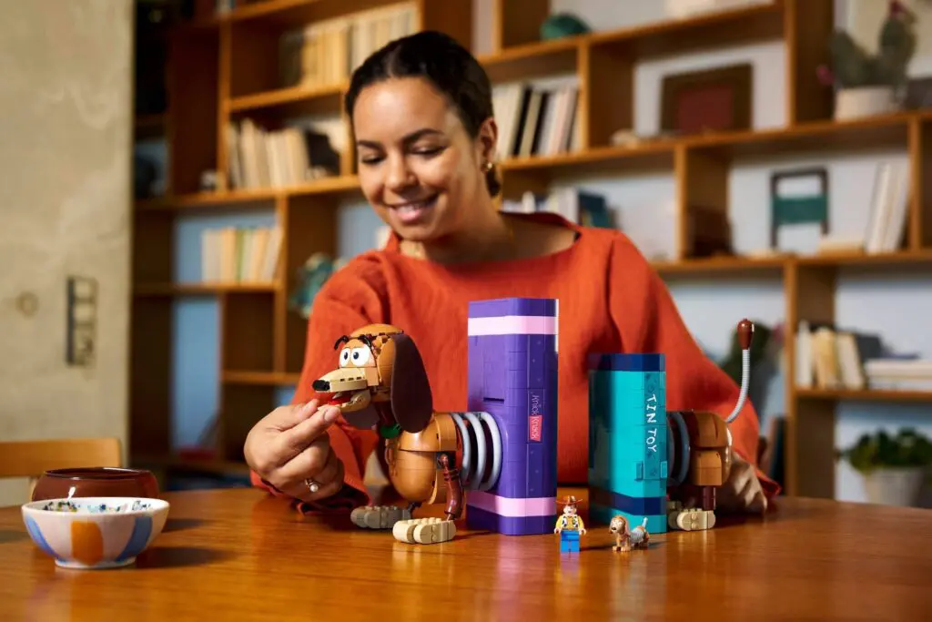 Woman interacting with toy figures on table