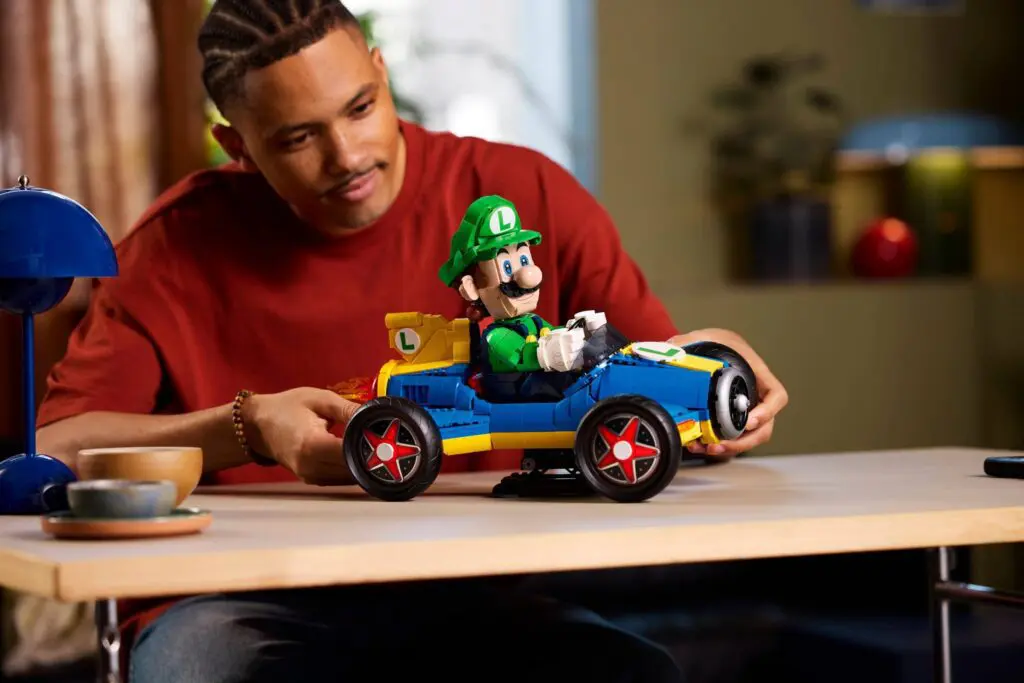 Luigi kart on table with smiling person