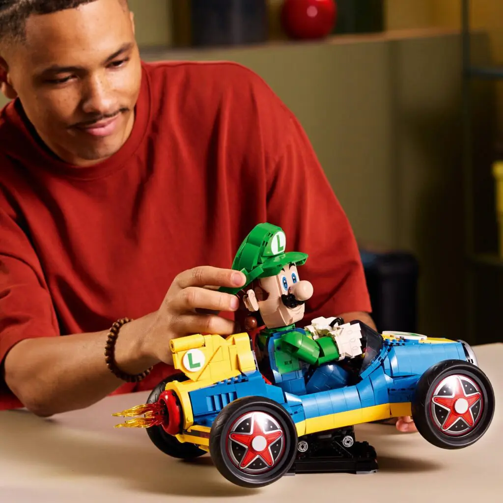 Man playing with Luigi-themed LEGO car