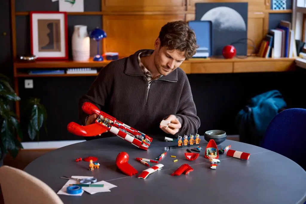 Building toy rocket pieces on table