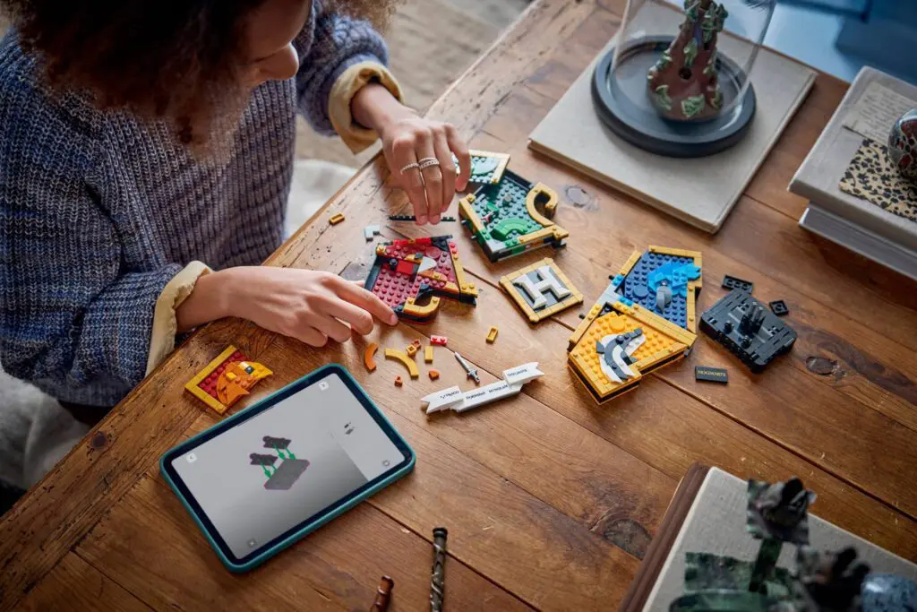 Building Lego pieces on wooden table.