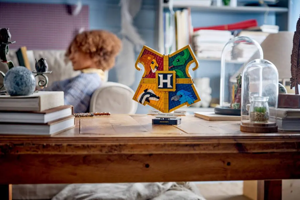 Child reading near Hogwarts shield